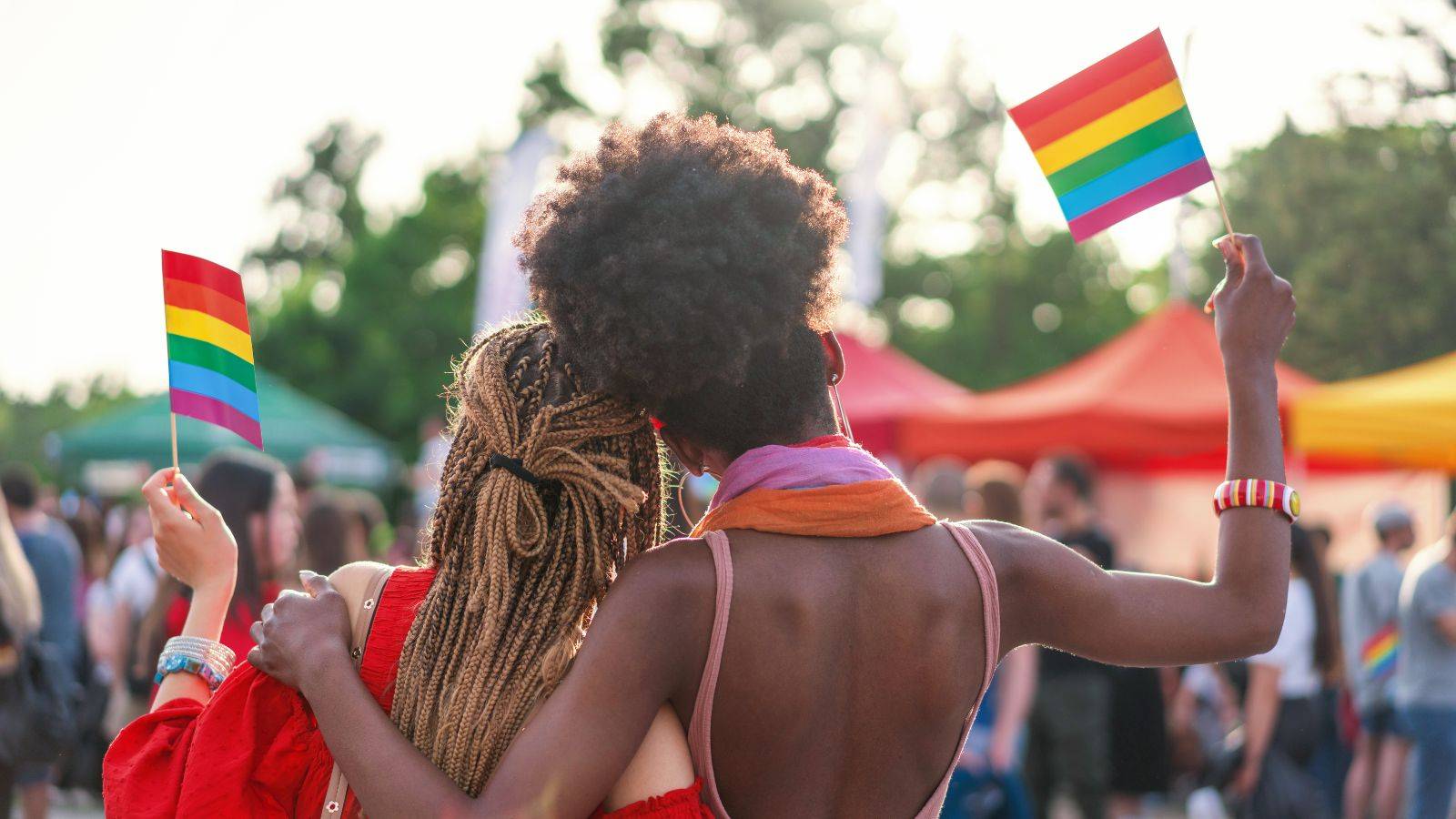 photo of two people holding pride flags celebrating pride month